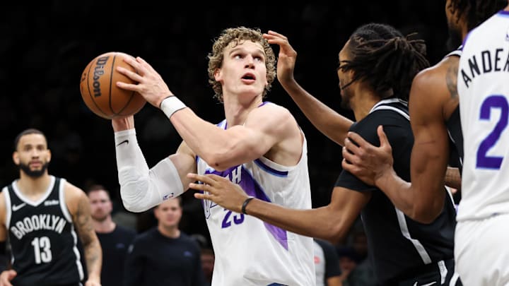 Dec 4, 2025; Brooklyn, New York, USA; Utah Jazz forward Lauri Markkanen (23) drives to the basket against Brooklyn Nets forward Ziaire Williams (1) during the fourth quarter at Barclays Center. Mandatory Credit: Tom Horak-Imagn Images