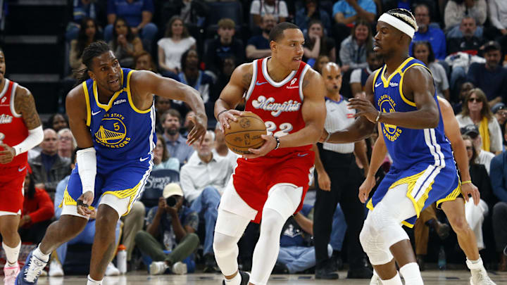 Memphis Grizzlies guard Desmond Bane against Golden State Warriors forward Kevon Looney and forward Jimmy Butler.