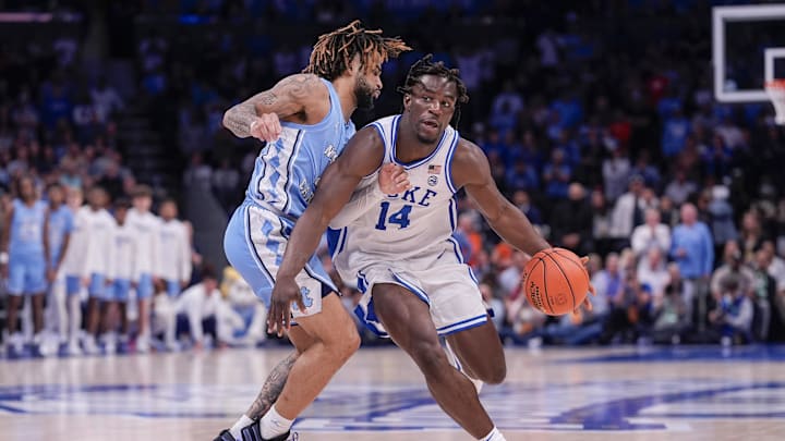 Duke's Sion James drives on North Carolina's RJ Davis in the ACC tournament.