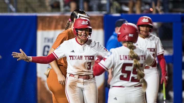 Jun 5, 2025; Oklahoma City, OK, USA;  Texas Tech Red Raiders utility Makayla Garcia (3) celebrates with utility Bailey Lindemuth (55) after scoring a run in the sixth inning against the Texas Longhorns during game two of the NCAA Softball Women's College World Series finals at Devon Park. Mandatory Credit: Brett Rojo-Imagn Images
