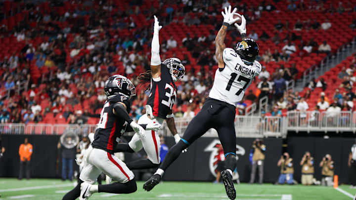 Aug 23, 2024; Atlanta, Georgia, USA; Jacksonville Jaguars tight end Evan Engram (17) catches a touchdown pass over Atlanta Falcons cornerback Jayden Price (36) and cornerback Kevin King (32) in the first quarter at Mercedes-Benz Stadium. 
