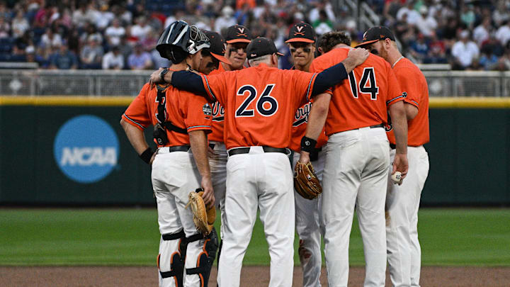 Jun 16, 2023; Omaha, NE, USA; Virginia Cavaliers head coach Brian O'Connor (26) gathers the infield during a break against the Florida Gators in the seventh inning at Charles Schwab Field Omaha. Mandatory Credit: Steven Branscombe-Imagn Images Jun 16, 2023; Omaha, NE, USA; Virginia Cavaliers head coach Brian O'Connor (26) gathers the infield during a break against the Florida Gators in the seventh inning at Charles Schwab Field Omaha. Mandatory Credit: Steven Branscombe-Imagn Images