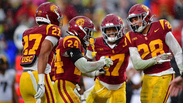 Los Angeles, California, USA; Southern California Trojans cornerback Alex Graham (27) safety Christian Pierce (24) cornerback Decarlos Nicholson (17) and safety Kennedy Urlacher (28) celebrate after Iowa Hawkeyes turn the ball over on fourth down during the second half at the Los Angeles Memorial Coliseum. Los Angeles, California, USA; Southern California Trojans cornerback Alex Graham (27) safety Christian Pierce (24) cornerback Decarlos Nicholson (17) and safety Kennedy Urlacher (28) celebrate after Iowa Hawkeyes turn the ball over on fourth down during the second half at the Los Angeles Memorial Coliseum.