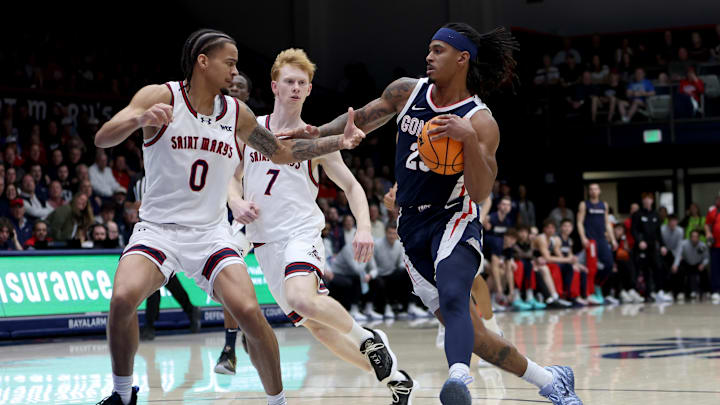 Gonzaga Bulldogs guard Adam Miller (23) drives towards the basket while being defended by Saint Mary's Gaels guard Mikey Lewis (0) during the first half at University Credit Union Pavilion. Gonzaga Bulldogs guard Adam Miller (23) drives towards the basket while being defended by Saint Mary's Gaels guard Mikey Lewis (0) during the first half at University Credit Union Pavilion.