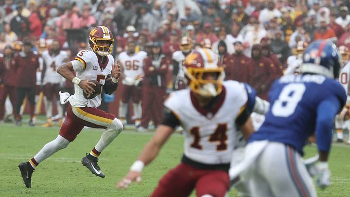Oct 11, 2026; Landover, Maryland, USA;  Washington Commanders quarterback Jayden Daniels (5) runs the ball for a touchdown against the New York Giants at Northwest Stadium.  Mandatory Credit: Geoff Burke-Imagn Images