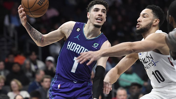 Dec 31, 2022; Charlotte, North Carolina, USA; Charlotte Hornets guard LaMelo Ball (1) controls the ball against Ben Simmons (10)