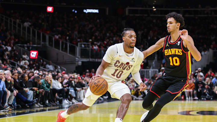 Nov 29, 2024; Atlanta, Georgia, USA; Cleveland Cavaliers guard Darius Garland (10) drives the ball towards the basket against Atlanta Hawks forward Zaccharie Risacher (10) during the fourth quarter at State Farm Arena. Mandatory Credit: Jordan Godfree-Imagn Images