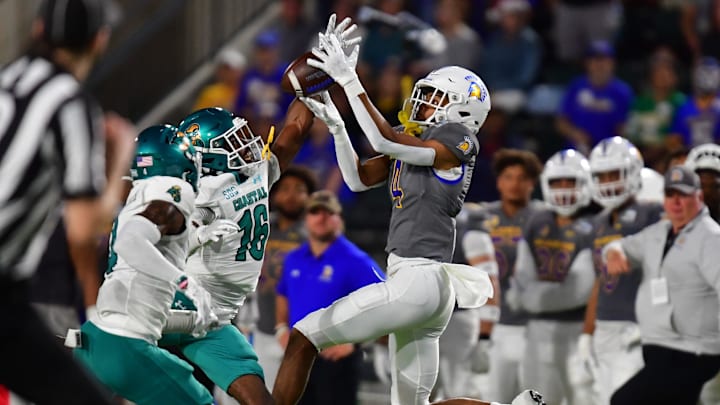 Dec 23, 2023; Honolulu, HI, USA; San Jose State Spartans wide receiver Charles Ross (4) fights for the ball against Coastal Carolina Chanticleers cornerback Matthew McDoom (16) and safety Tobias Fletcher (4) during the second quarter of the Easypost Hawaii Bowl at Clarence T.C. Ching Athletics Complex. Mandatory Credit: Steven Erler-Imagn Images