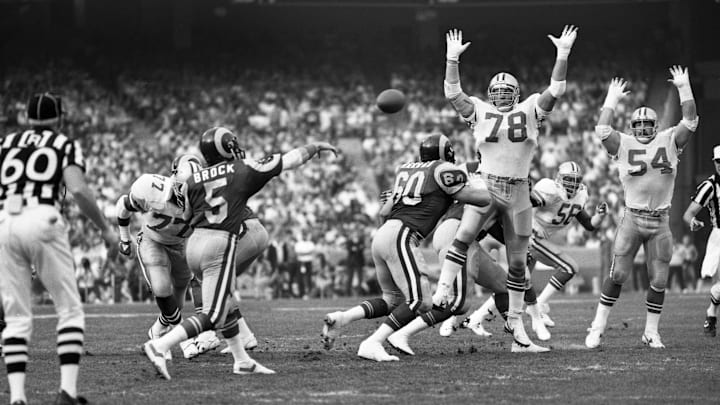Jan 4, 1986; Anaheim, CA, USA; FILE PHOTO; Dallas Cowboys defensive end John Dutton (78) and Randy White (54) defend against Los Angeles Rams quarterback Dieter Brock (5) during the 1985 NFC Divisional Playoff Game at Anaheim Stadium. The Rams defeated the Cowboys 20-0.