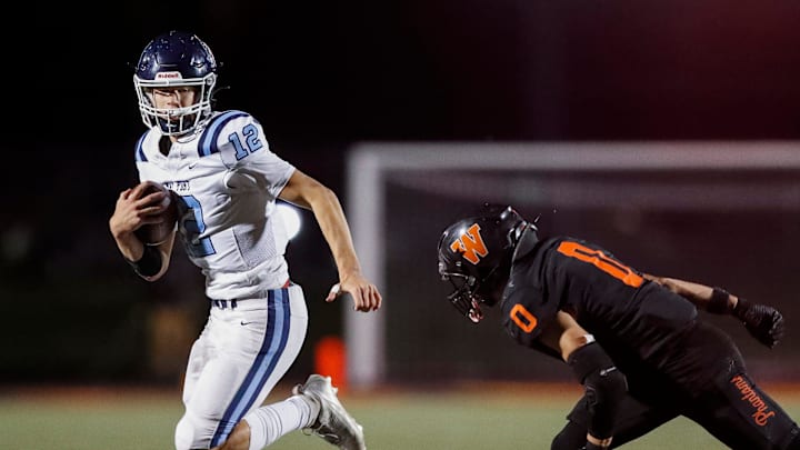Bay Port High School's Matt Stevens (12) runs away from West De Pere High School's Laliwa Delgado (0) on Friday, October 10, 2025, at West De Pere High School in De Pere, Wis. West De Pere won the game, 48-45, after trailing by 17 points with four minutes to play. Tork Mason/USA TODAY NETWORK-Wisconsin