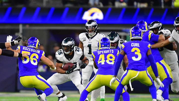 Nov 24, 2024; Inglewood, California, USA; Philadelphia Eagles running back Saquon Barkley (26) runs the ball against Los Angeles Rams linebacker Christian Rozeboom (56) and linebacker Omar Speights (48) during the first half at SoFi Stadium. Mandatory Credit: Gary A. Vasquez-Imagn Images