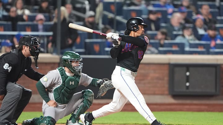 Apr 10, 2026; New York City, New York, USA; New York Mets shortstop Francisco Lindor (12) hits a single against the Athletics during the sixth inning at Citi Field. Mandatory Credit: Gregory Fisher-Imagn Images