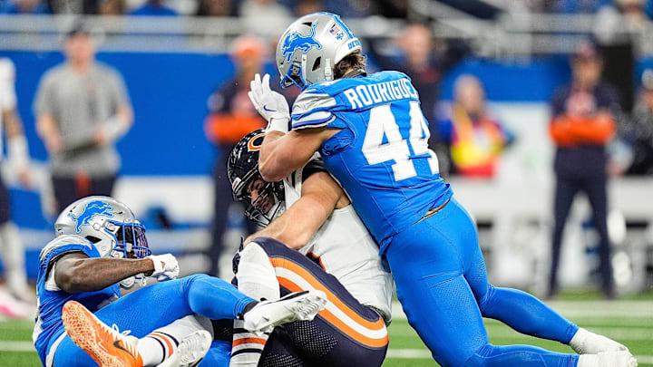 Detroit Lions linebacker Malcolm Rodriguez (44) tackles Chicago Bears tight end Cole Kmet (85) during the first half at Ford Field in Detroit on Thursday, Nov. 28, 2024.