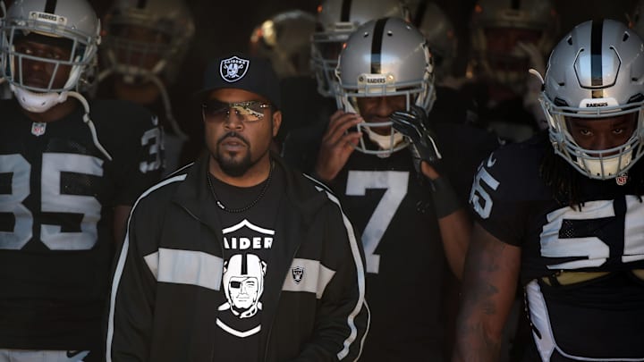 Oct 19, 2014; Oakland, CA, USA; Recording artist and entertainer Ice Cube leads Oakland Raiders players onto the field before the game against the Arizona Cardinals at O.co Coliseum. Mandatory Credit: Kirby Lee-Imagn Images

