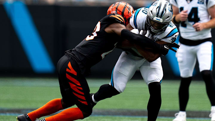 Cincinnati Bengals cornerback Dax Hill (23) tackles Carolina Panthers running back Chuba Hubbard (30) in the second quarter of the NFL game at Bank of America Stadium in Charlotte, N.C., on Sunday, Sept. 29, 2024.