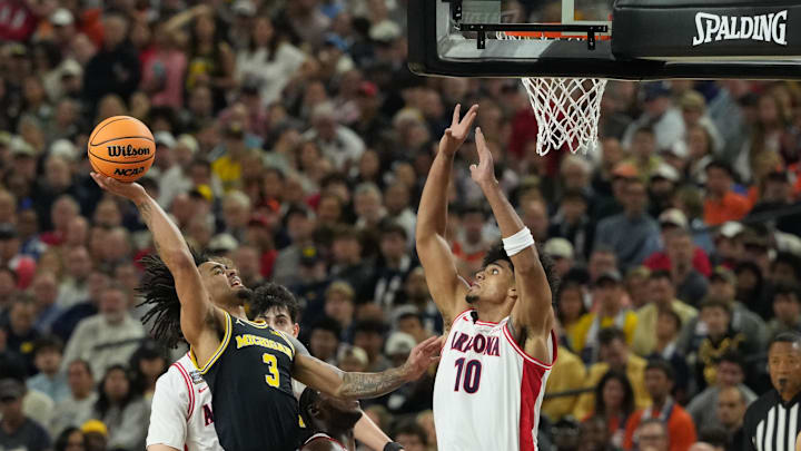 Apr 4, 2026; Indianapolis, IN, USA; Michigan Wolverines guard Elliot Cadeau (3) shoots against Arizona Wildcats forward Koa Peat (10) in the first half during a semifinal of the Final Four of the men's 2026 NCAA Tournament at Lucas Oil Stadium. Mandatory Credit: Robert Deutsch-Imagn Images Apr 4, 2026; Indianapolis, IN, USA; Michigan Wolverines guard Elliot Cadeau (3) shoots against Arizona Wildcats forward Koa Peat (10) in the first half during a semifinal of the Final Four of the men's 2026 NCAA Tournament at Lucas Oil Stadium. Mandatory Credit: Robert Deutsch-Imagn Images