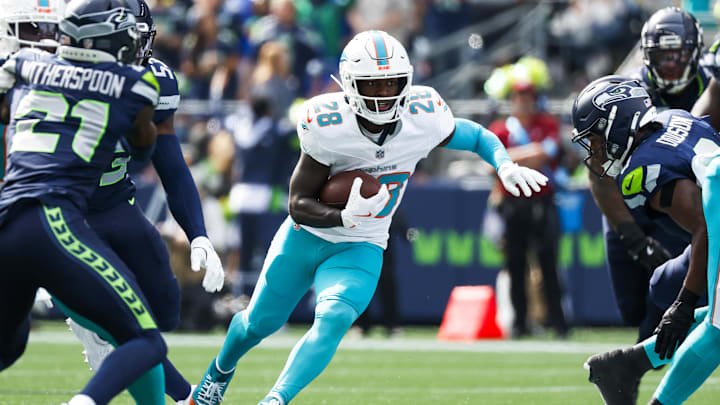 Sep 22, 2024; Seattle, Washington, USA; Miami Dolphins running back DeVon Achane (28) rushes against the Seattle Seahawks during the first quarter at Lumen Field. Mandatory Credit: Joe Nicholson-Imagn Images