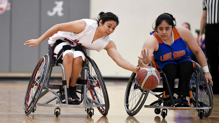 Mar 11, 2023; Tuscaloosa, AL, USA;  UT Arlington's Denise Rodriguez (33) and Alabama's Ixhelt Gonzalez (54) work to grab a loose ball. The Crimson Tide defeated UT-Arlington 88-41 to claim the team's 9th national championship