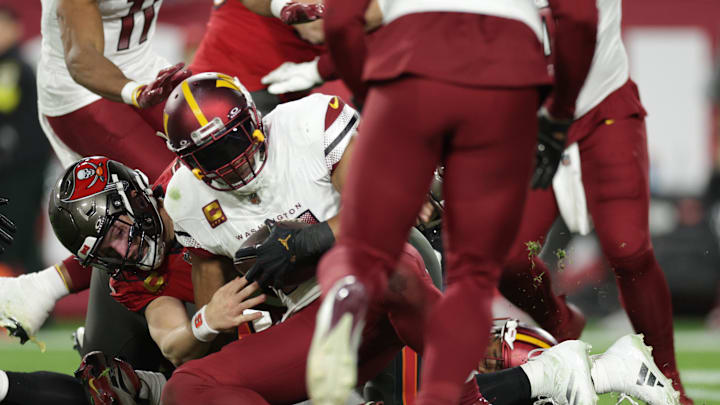 Jan 12, 2025; Tampa, Florida, USA; Washington Commanders linebacker Bobby Wagner (54) recovers a fumble by Tampa Bay Buccaneers quarterback Baker Mayfield (6) during the fourth quarter of a NFC wild card playoff at Raymond James Stadium. Mandatory Credit: Nathan Ray Seebeck-Imagn Images