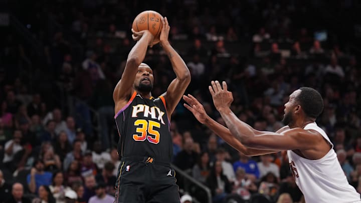 Mar 21, 2025; Phoenix, Arizona, USA; Phoenix Suns forward Kevin Durant (35) shoots against Cleveland Cavaliers forward Evan Mobley (4) during the second half at Footprint Center. Mandatory Credit: Joe Camporeale-Imagn Images