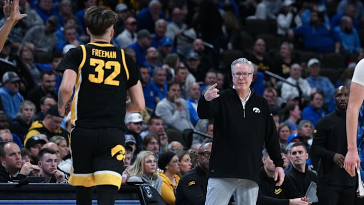 Owen Freeman heads toward former Iowa head coach Fran McCaffery.