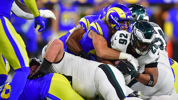 Nov 24, 2024; Inglewood, California, USA; Philadelphia Eagles running back Saquon Barkley (26) is brought down by Los Angeles Rams linebacker Christian Rozeboom (56) during the second half at SoFi Stadium. Mandatory Credit: Gary A. Vasquez-Imagn Images Nov 24, 2024; Inglewood, California, USA; Philadelphia Eagles running back Saquon Barkley (26) is brought down by Los Angeles Rams linebacker Christian Rozeboom (56) during the second half at SoFi Stadium. Mandatory Credit: Gary A. Vasquez-Imagn Images