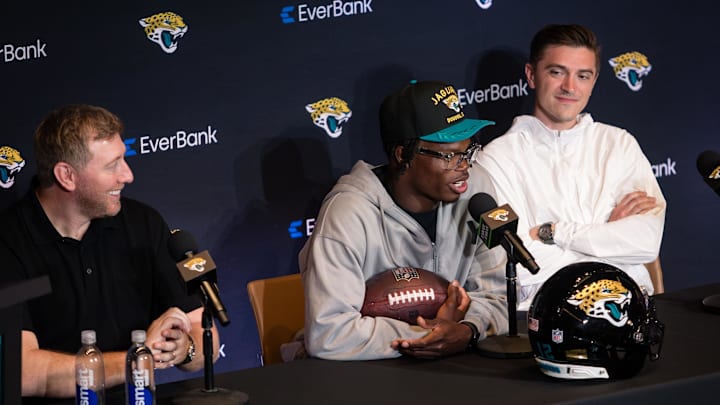 Apr 25, 2025; Jacksonville, FL, USA; Jacksonville Jaguars first round draft pick Travis Hunter talks to the media beside head coach Liam Coen and general manager James Gladstone during a press conference at Miller Electric Center. Mandatory Credit: Travis Register-Imagn Images