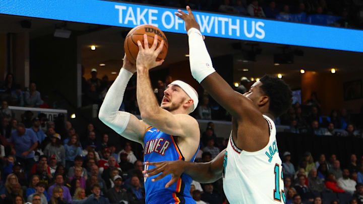 Feb 8, 2025; Memphis, Tennessee, USA; Oklahoma City Thunder guard Alex Caruso (9) drives to the basket as Memphis Grizzlies forward Jaren Jackson Jr. (13) defends during the first quarter at FedExForum. Mandatory Credit: Petre Thomas-Imagn Images Feb 8, 2025; Memphis, Tennessee, USA; Oklahoma City Thunder guard Alex Caruso (9) drives to the basket as Memphis Grizzlies forward Jaren Jackson Jr. (13) defends during the first quarter at FedExForum. Mandatory Credit: Petre Thomas-Imagn Images