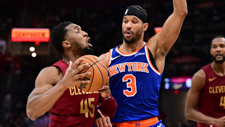 Apr 2, 2025; Cleveland, Ohio, USA; Cleveland Cavaliers guard Donovan Mitchell (45) drives to the basket against New York Knicks guard Josh Hart (3) during the second half at Rocket Arena. Mandatory Credit: Ken Blaze-Imagn Images