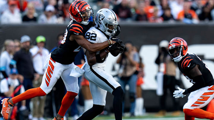 Cincinnati Bengals cornerback DJ Turner II (20) tackles Las Vegas Raiders wide receiver Ramel Keyton (82) in the fourth quarter of the NFL game at Paycor Stadium in Cincinnati on Sunday, Nov. 3, 2024.