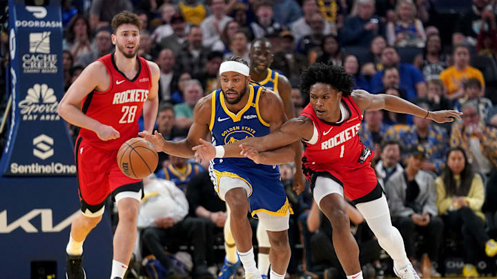 Apr 6, 2025; San Francisco, California, USA; Golden State Warriors guard Moses Moody (4) dribbles the balll next to Houston Rockets forward Amen Thompson (1) in the first quarter at the Chase Center. Mandatory Credit: Cary Edmondson-Imagn Images
