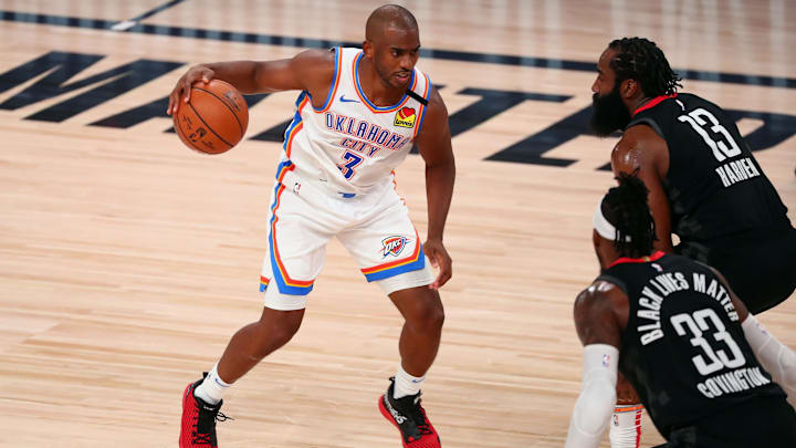 Sep 2, 2020; Lake Buena Vista, Florida, USA; Oklahoma City Thunder guard Chris Paul (3) drives against Houston Rockets forward Robert Covington (33) and guard James Harden (13) during the first half of game seven of the first round of the 2020 NBA Playoffs at ESPN Wide World of Sports Complex. Mandatory Credit: Kim Klement-Imagn Images Sep 2, 2020; Lake Buena Vista, Florida, USA; Oklahoma City Thunder guard Chris Paul (3) drives against Houston Rockets forward Robert Covington (33) and guard James Harden (13) during the first half of game seven of the first round of the 2020 NBA Playoffs at ESPN Wide World of Sports Complex. Mandatory Credit: Kim Klement-Imagn Images