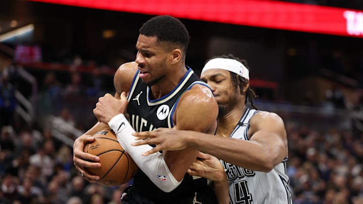 Milwaukee Bucks forward Giannis Antetokounmpo (34) and Orlando Magic center Wendell Carter Jr. (34) fight for a loose ball in the fourth quarter at Kia Center.