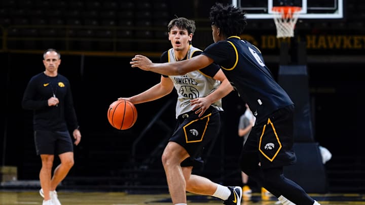 Iowa’s Trey Thompson (20) dribbles the ball as Tavion Banks (6) defends during practice Oct. 15, 2025 at Carver-Hawkeye Arena in Iowa City, Iowa.