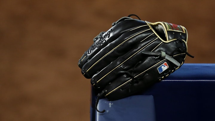 May 7, 2021; Miami, Florida, USA; A baseball glove rest over a handrail in the dugout of the