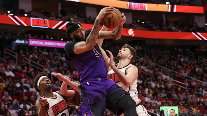 Jan 5, 2025; Houston, Texas, USA;  Los Angeles Lakers forward Anthony Davis (3) grabs a defensive rebound against Houston Rockets center Alperen Sengun (28) in the second quarter at Toyota Center. Mandatory Credit: Thomas Shea-Imagn Images