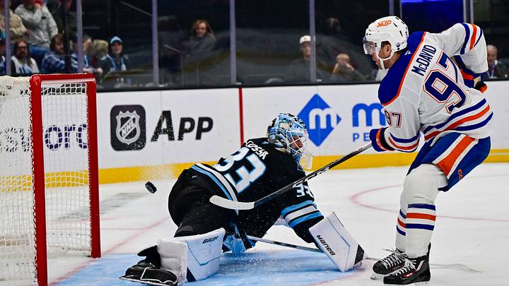 Oct 17, 2026; Salt Lake City, Utah, USA;  Edmonton Oilers center Connor McDavid (97) scores a goal on Utah Mammoth goalie Sebastian Cossa (33) during third period at Delta Center.  Mandatory Credit: Peter Creveling-Imagn Images