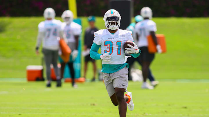 Jun 4, 2024; Miami Gardens, FL, USA; Miami Dolphins running back Raheem Mostert (31) runs with the football during mandatory minicamp at Baptist Health Training Complex. Mandatory Credit: Sam Navarro-USA TODAY Sports