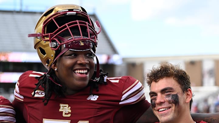 Boston College Eagles offensive lineman Jude Bowry (71), wide receiver Luke McLaughlin (83) and head coach Bill O'Brien celebrate.