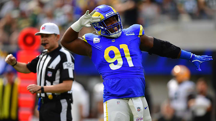 Oct 6, 2024; Inglewood, California, USA; Los Angeles Rams defensive tackle Kobie Turner (91) reacts after sacking Green Bay Packers quarterback Jordan Love (10) during the first half at SoFi Stadium. Mandatory Credit: Gary A. Vasquez-Imagn Images