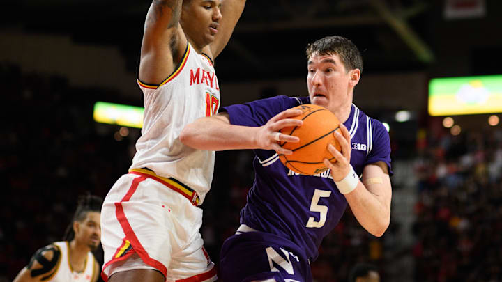 Mar 8, 2025; College Park, Maryland, USA; Northwestern Wildcats center Keenan Fitzmorris (5) handles the ball against Maryland Terrapins forward Julian Reese (10) during the first half at Xfinity Center. Mandatory Credit: Reggie Hildred-Imagn Images