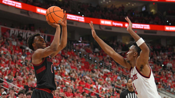 Mar 7, 2026; Raleigh, North Carolina, USA;  Stanford Cardinal guard Ebuka Okorie (1) shoots the ball against NC State Wolfpack guard Paul McNeil Jr. (2) during the second half at Lenovo Center. Mandatory Credit: Zachary Taft-Imagn Images