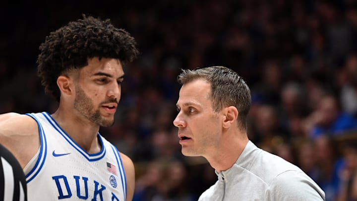 Jan 10, 2026; Durham, North Carolina, USA; Duke Blue Devils forward Cameron Boozer (12) talks to head coach Jon Scheyer during the first half against the Southern Methodist Mustangs at Cameron Indoor Stadium. Mandatory Credit: Rob Kinnan-Imagn Images Jan 10, 2026; Durham, North Carolina, USA; Duke Blue Devils forward Cameron Boozer (12) talks to head coach Jon Scheyer during the first half against the Southern Methodist Mustangs at Cameron Indoor Stadium. Mandatory Credit: Rob Kinnan-Imagn Images