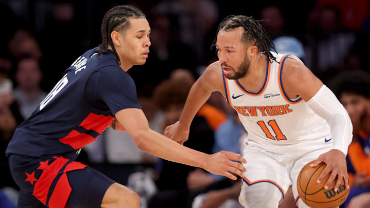 Nov 18, 2024; New York, New York, USA; New York Knicks guard Jalen Brunson (11) controls the ball against Washington Wizards forward Kyshawn George (18) during the second quarter at Madison Square Garden. Mandatory Credit: Brad Penner-Imagn Images