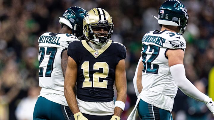 Sep 22, 2024; New Orleans, Louisiana, USA; New Orleans Saints wide receiver Chris Olave (12) reacts to making a first down reception against Philadelphia Eagles safety Reed Blankenship (32) during the first half at Caesars Superdome. Mandatory Credit: Stephen Lew-Imagn Images
