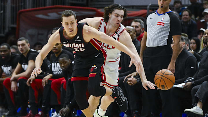 Feb 4, 2025; Chicago, Illinois, USA;  Chicago Bulls guard Josh Giddey (3) and Miami Heat forward Duncan Robinson (55) chase the ball during the first half at United Center. Mandatory Credit: Matt Marton-Imagn Images