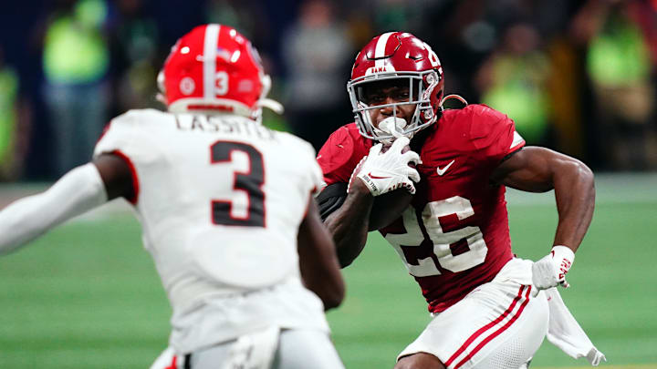 Dec 2, 2023; Atlanta, GA, USA;  Alabama Crimson Tide running back Jam Miller (26) runs against Georgia Bulldogs defensive back Kamari Lassiter (3) in the fourth quarter of the SEC Championship at Mercedes-Benz Stadium. Mandatory Credit: John David Mercer-Imagn Images