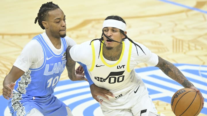 Dec 23, 2024; Cleveland, Ohio, USA; Cleveland Cavaliers guard Darius Garland (10) defends Utah Jazz guard Jordan Clarkson (00) in the fourth quarter at Rocket Mortgage FieldHouse. Mandatory Credit: David Richard-Imagn Images