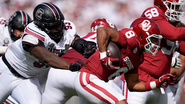 Oklahoma Sooners running back Taylor Tatum (8) runs past South Carolina Gamecocks defensive tackle Nick Barrett (93) during a college football game between the University of Oklahoma Sooners (OU) and the South Carolina Gamecocks at Gaylord Family - Oklahoma Memorial Stadium in Norman, Okla., Saturday, Oct. 19, 2024.