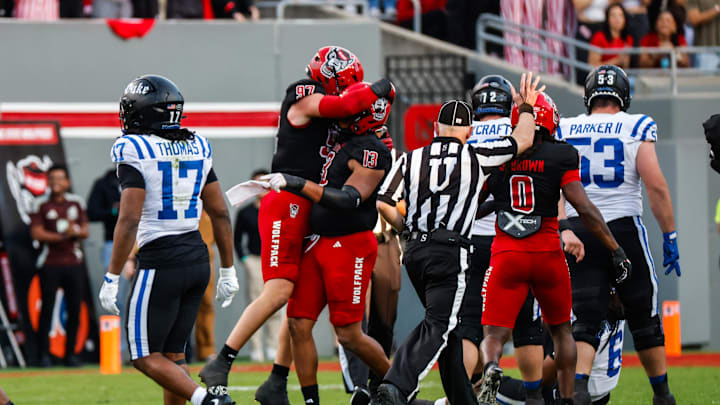 Nov 9, 2024; Raleigh, North Carolina, USA; North Carolina State Wolfpack defensive end Noah Potter (97) defensive end Travali Price (13) celebrate during the first half of the game against Duke Blue Devils at Carter-Finley Stadium. Mandatory Credit: Jaylynn Nash-Imagn Images